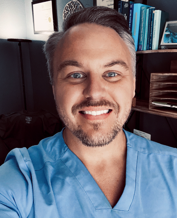 Dr. Levi Armstrong smiling in his office.